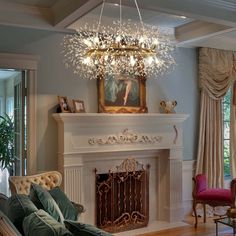 a living room filled with furniture and a fire place under a chandelier above a fireplace