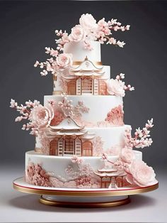 a three tiered cake with pink flowers on it