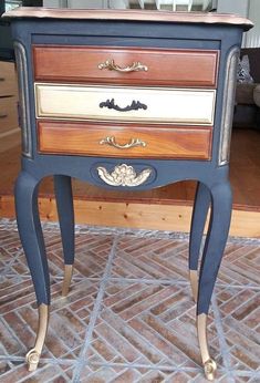 a blue and brown table with drawers on it