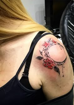 a woman with a tattoo on her shoulder