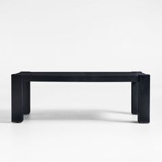 a black bench sitting on top of a white floor