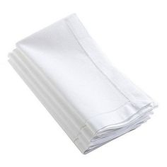 four white napkins stacked on top of each other