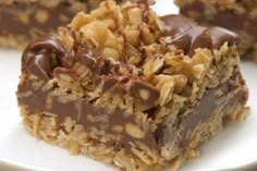 two pieces of chocolate and oatmeal bars on a white plate with the words, toffe brownies