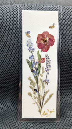 a card with flowers and butterflies on it