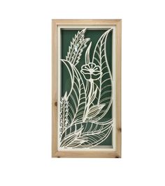 a wooden frame with white paper cut flowers and leaves on the front, against a green background