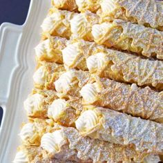 a white plate topped with lots of desserts on top of a blue table cloth