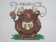 a cross stitch picture of a bull with the word taurus on it's chest