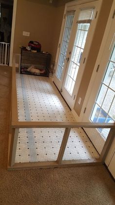 an empty living room with sliding glass doors and tile flooring in the middle of it