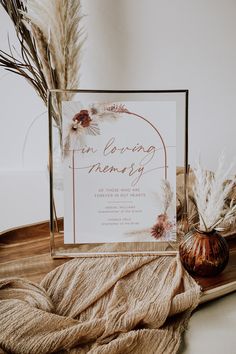 there is a sign that says masks available on the table next to some dried plants