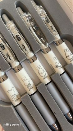 an assortment of different types of toothbrushes in a gray case with mickey mouse writing on them