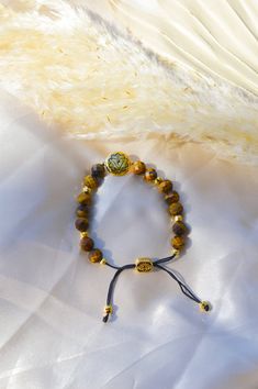 Amplify spiritual and psychic protection, and protect your personal power with our Solar Plexus Chakra Tiger's Eye Energy Protection and Psychic Power Bracelet. The Solar Plexus Chakra, also known as the Manipura Chakra, is in the pit of the abdomen, above the navel. It is responsible for personal strength and will; it is where the essence of confidence andidentity is embedded. When the Solar Plexus Chakra is awakened, the energy flows freely, clearing any self-doubt and insecurity, kindling int Gold Hand-wrapped Spiritual Stretch Bracelet, Yellow Chakra Solar Plexus, Spiritual Orange Hand-strung Stretch Bracelet, Spiritual Gold Crystal Bracelet, Hypoallergenic, Sacred Geometry Jewelry, Tiger's Eye Bracelet, Manipura Chakra, Power Bracelet, Lotus Jewelry