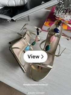 a pair of women's shoes sitting on top of a table next to a book