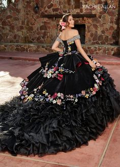 Look unforgettable in this embroidered floral applique long off shoulder velvet dress with A-line ruffled skirt by Rachel Allan RQ3111. Charro style quinceanera ball gown features beaded off-the-shoulder neck line, multi-color floral applique on velvet bodice and skirt overlays, organza ruffle skirt, cathedral train, and lace-up back closure. Off Shoulder Ruffled Quinceanera Dress by Rachel Allan RQ3111 Rachel Allan Charro Collection: Fall 2023 Style Number: RQ3111 Fabric: Velvet, Organza, Appli Quinceanera Dresses Mexican, Quinceanera Dresses Black, Vestido Charro, Charro Quinceanera, Quinceanera Themes Dresses, Mexican Quinceanera Dresses, Black Quinceanera Dresses, Charro Quinceanera Dresses, Peplum Designs