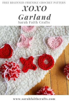 crochet valentine garland with red and white hearts on it, next to yarn balls