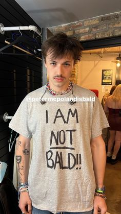 a man wearing a shirt that says i am not bald