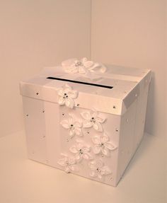 a white gift box with flowers on it