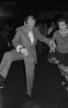 an old photo of two people dancing