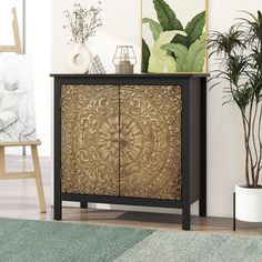 a wooden cabinet with carvings on it in a living room next to a potted plant