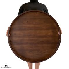 a person holding a large wooden board on their back with one hand and the other