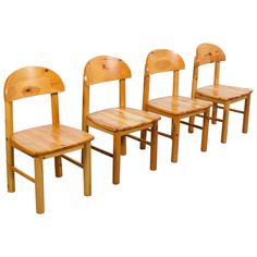 four wooden chairs sitting next to each other