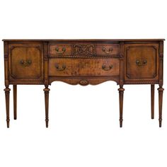 an antique wooden sideboard with three drawers and one drawer on the bottom, against a white background