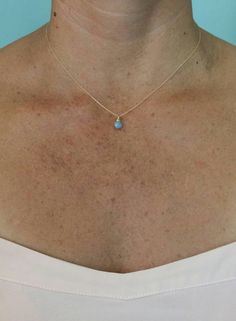 "A simple tiny blue opal stone suspended from a delicate gold filled or sterling silver chain. Perfect for adding a touch of color to any layered ensemble. The stone is a tiny 7mm and a beautiful opaque periwinkle blue color. It matches everything! Shown here in 16\" length. *If you are unsure of the length you need, or would like to wear this item at different lengths, we now offer an adjustable length option! You can add an adjustable end to your necklace using this link: https://www.etsy.com/ Dainty Tiny Opal Jewelry, Tiny Dainty Opal Jewelry, Minimalist Blue Birthstone Necklace, Blue Birthstone Charm Necklace, Blue Birthstone Dainty Jewelry, Dainty Blue Birthstone Jewelry, Blue Dainty Birthstone Jewelry, Simple Blue Everyday Jewelry, Dainty Blue Charm Necklace For Everyday