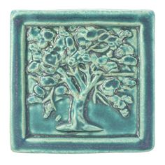 a ceramic tile with a tree on it