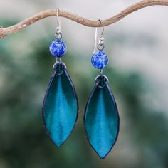 Working with leather, Thai artisan Chaloemphon creates fabulous jewelry with contemporary flair. These earrings feature supple leather petals in blue-green, topped by polished beads of lapis lazuli. The earrings swing from polished sterling silver hooks. Blue Bohemian Leather Earrings, Bohemian Blue Leather Earrings, Blue Leather Bohemian Earrings, Handmade Blue Leather Earrings, Elegant Blue Leather Jewelry, Green Leather Dangle Jewelry, Green Leather Dangle Earrings, Imperial Leather, Lapis Lazuli Earrings