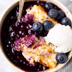 a bowl filled with blueberry cobbler and ice cream