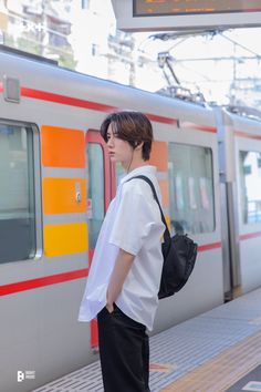 a young man is waiting for the train to arrive