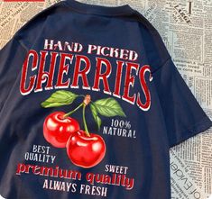 Indulge in the sweetness of summer with our "Hand Picked Cherries" T-Shirt, a delightful tribute to nature's bounty and carefree days in the orchard. Crafted from soft, breathable cotton, this tee offers comfort and style in equal measure. The design features a vibrant graphic of hand-picked cherries, capturing the essence of freshness and abundance. Whether you're lounging at a picnic, exploring farmers' markets, or simply embracing the joy of seasonal fruit, this shirt is a charming addition t Cheap Trendy Tops With Cherry Print, Cheap Red Cherry Print T-shirt, Chloe Cherry Shirts, Sweet Nothing Shirt, Cheap Short Sleeve T-shirt With Cherry Print, Chloe Cherry T Shirt, Cece Shirt, Cotton Craft, Blue Army