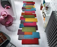 a colorful rug is on the floor next to a radiator and heater