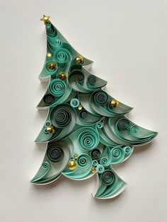 an origami christmas tree made out of green paper with gold decorations on it