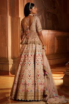 Blush pink raw silk lehenga with multicolor resham embroidery with attached can-can, zari, dabka, beadwork and crystals. Comes with matching embroidered padded peplum top and tulle dupatta.
Component: 3
Pattern: Embroidered
Type Of Work: Floral Resham, Zari, Dabka, Beads and Sequins
Neckline: Plunged V-Neck
Sleeve Type: Half
Fabric: Raw Silk, Tulle
Color: Pink
Other Details: 
Sheer peplum panels
Back tassel tie-up
Scalloped hem details
Occasion: Bride, Wedding - Aza Fashions Silk Choli With Tilla For Wedding, Designer Raw Silk Choli With Tilla, Designer Raw Silk Choli With Tilla Details, Pink Art Silk Lehenga With Tilla, Pink Art Silk Lehenga With Tilla Embroidery, Pink Art Silk Lehenga With Tilla Detailing, Wedding Sets In Raw Silk With Tilla Detailing, Tilla Embellished Raw Silk Sharara For Wedding, Wedding Sharara In Raw Silk With Tilla Details