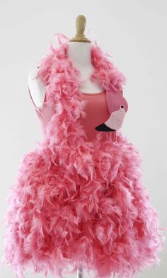 a pink dress on a mannequin with feathers