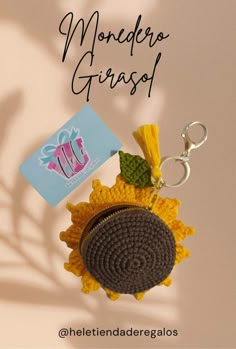 a sunflower keychain with a tag attached to it and the words monedero giraso above it