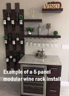 a wine rack with bottles and glasses on it next to a wall mounted wine glass holder