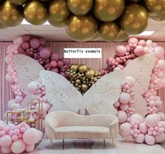 a room filled with balloons and furniture in front of a pink curtained wall that has a large butterfly on it