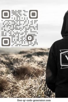 a person wearing a black hoodie standing in front of a field with qr code on it