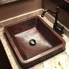 a bathroom sink with a faucet in the middle and marble counter top next to it