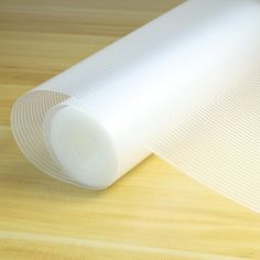 a roll of white paper sitting on top of a wooden table