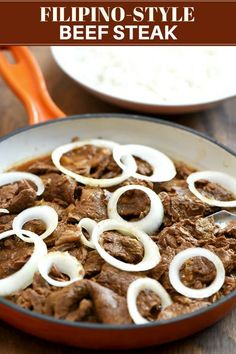 a skillet filled with beef and onions on top of a wooden table