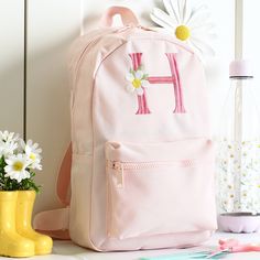 Embroidered Nursery backpack Back to School and Nursery never looked so good as when your little one is wearing one of our stunning embroidered backpacks.  With a choice of backpack colours and over 25+ embroidery colours there are endless colour combinations to choose from. PLEASE NOTE WE ARE INCREDIBLY BUSY WITH ORDERS, PLEASE ORDER EARLY TO AVOID DISAPPOINTENT DETAILS: - Size: 35 x 23 x 12cm - Water resistant - Wipe clean lining - Padded back panel for durability and comfort - Strong grab han Pink School Bags With Letter Embroidery, School Backpack With Letter Embroidery, School Backpack With Embroidered Logo, Embroidered Backpack For Everyday And Back To School, Pink Embroidered School Bag, Pink Embroidered School Bags, Embroidered Backpack For Students, Student Embroidered Standard Backpack, Embroidered Student Backpack