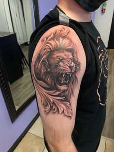 a man with a lion tattoo on his arm