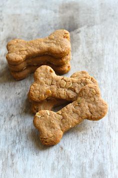 three cookies shaped like hearts sitting on top of a wooden table