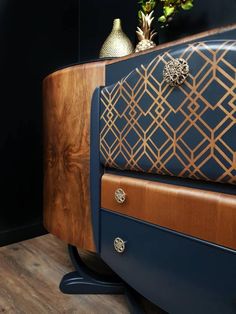 a close up of a blue and brown bench with flowers on the top shelf next to it