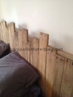 the headboard is made out of wooden boards