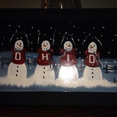 three snowmen are standing in the snow