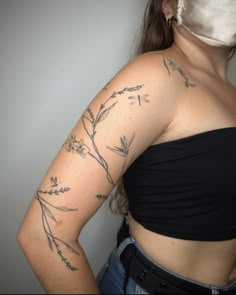 a woman with tattoos on her arms and shoulder