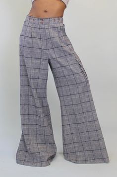 Italian recycled Tartan Plaid wide leg Cargo trouser. Double button closure above zipper at center front waistline. Side and back pockets. Cargo Pocket located at wearer's right leg. Pleats down center front of each pant leg. Pant measures 41 3/4" from waist with 32" inseam. Grey Plaid, Tracy Reese, Cargo Pocket, Plaid Pants, Cargo Trousers, Tartan Plaid, Fabric Collection, Sustainable Fashion, Casual Pants